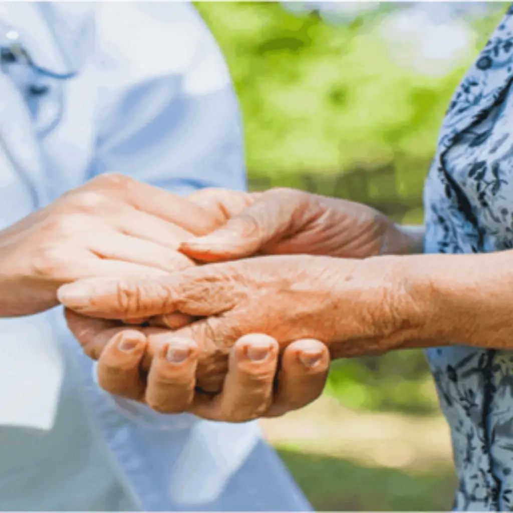 Dr handing hand of an older lady.